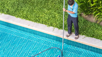 Technician brushing a pool